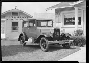 Ford sedan on lawn, Southern California, 1930