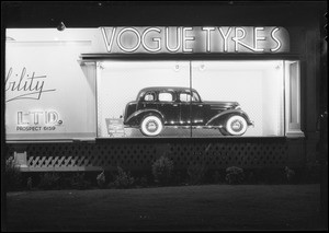 Vogue Tyre board with Chevrolet sedan, Southern California, 1935