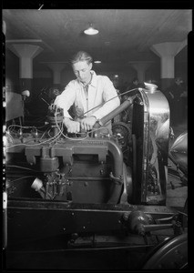 Men working on motor of car, National Auto School, Southern California, 1930