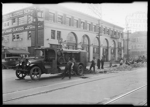 Mexican students watching men work on streetcar tracks, National Auto School, Southern California, 1931