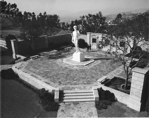 A high-angle shot of the Sculpture of David with the mountains in the background at the Forest Lawn Memorial Park