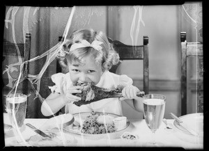 Kiddie eating turkey leg, Southern California, 1935