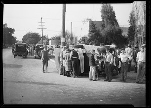 Auto wreck, people looking on, car turned over, Southern California, 1930