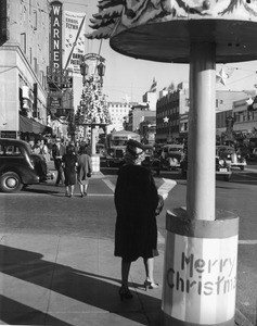 Hollywood Boulevard at Christmas time, with the Warner Hollywood Theatre playing "The Dawn Patrol" with Errol Flynn, ca.1938-1939