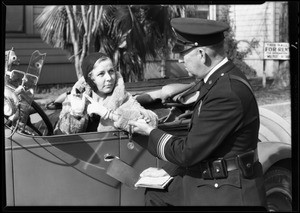 Officer and girl with watch, Southern California, 1930