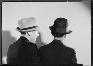 Men watching Wilbur Shaw shooting at tire, Southern California, 1934