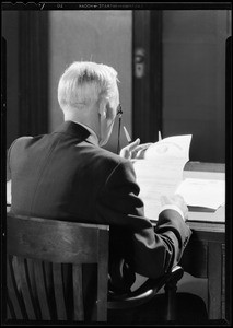 Business man reading policy, Southern California, 1930