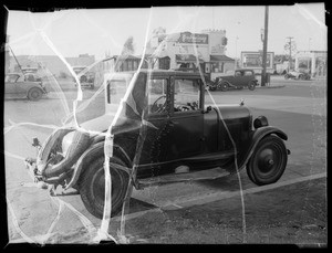 Chevrolet coupe and Ford coupe, license #8D50, intersection of Crenshaw Boulevard and Jefferson Boulevard, Los Angeles, CA, 1935