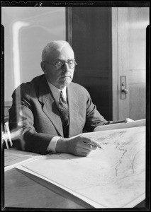 Mr. Weymouth looking over maps, Metropolitan Water District, Southern California, 1931