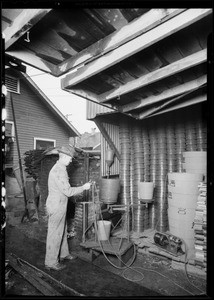 Man spraying tubs, California Tub Co., 1236 East 49th Street, Los Angeles, CA, 1930