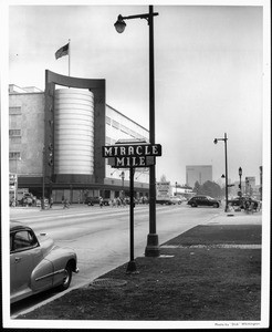 A view of the Miracle Mile sign with the May Company in the background