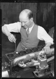 Earl Cooper measuring diameter of cylinder, Southern California, 1934