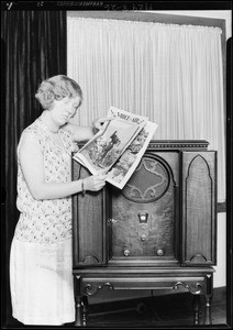 Lady holding "Voice of the Air" magazine with radio, Majestic Radio, Southern California, 1929