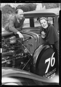 Earl Cooper and microphone on motor of car, Southern California, 1932