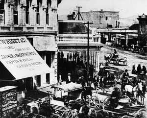 People with horses and buggies crowd the downtown streets