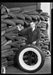 Mr. Price and stack of old tires, Southern California, 1930