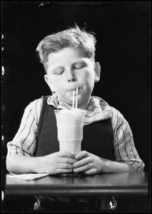 Boy eating ice cream soda, Southern California, 1932