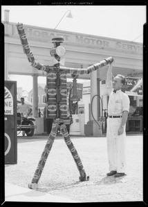 Tin can man at 3rd and Hobart filling station, West 3rd Street and South Hobart Boulevard, Los Angeles, CA, 1933