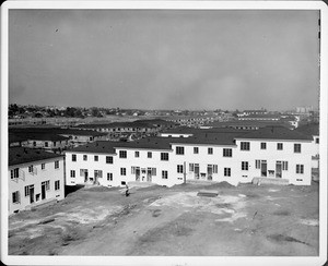 Wyvernwood Housing complex with 2-story units divided by greenbelt and walkways under construction