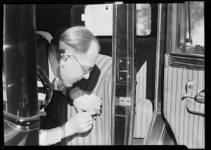 Man with safety pin and seat cover, National Auto Top Co., Southern California, 1930