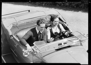 Couple speeding in open roadster, Southern California, 1931