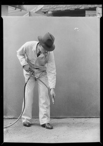 Pipe end, man holding Alemite gun, Southern California, 1932