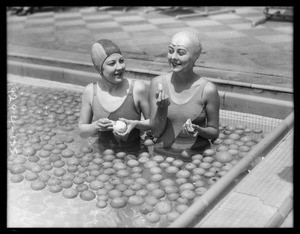Ambassador plunge, girls swimming in pool of oranges, Los Angeles, CA, 1929