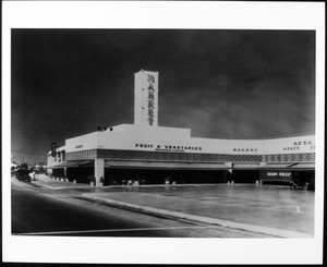 A market advertising wholesale and retail fruit and vegetables and baby beef