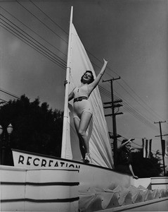 A woman on a sailboat in the American Legion Parade