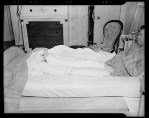 Mr. Altman in bed showing broken leg in cast, 4002 West 7th Street, Los Angeles, CA, 1940