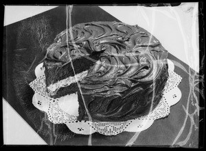 Cake and girl frosting cake, Southern California, 1936