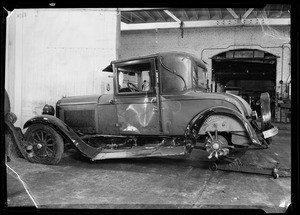 Wrecked Pontiac coupe at globe garage, Southern California, 1935