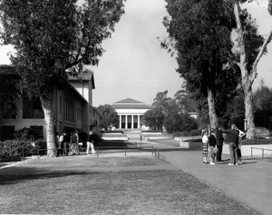 Two groups of students congregate on the campus of Occidental College