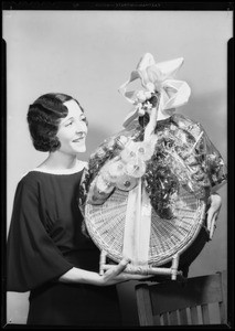 Mrs. Paige and basket of fancy fruits, Southern California, 1932