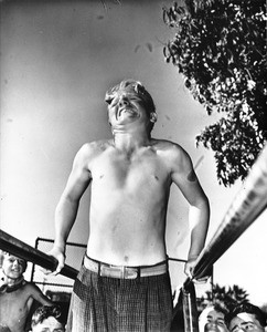 A young man practices on the parallel bars at a Los Angeles playground