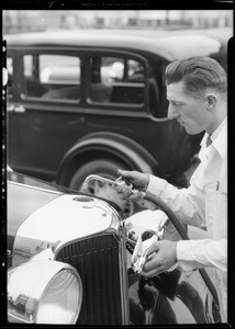 Man filling Chrysler radiator, Southern California, 1931