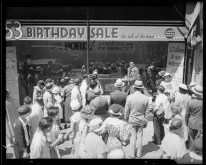 Crowd looking at winners in May Co. window, Southern California, 1934