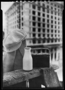 Milk bottle, dinner pail, building background, Southern California, 1936