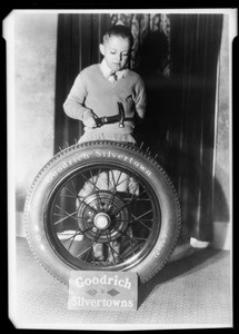 Boy and tire, Pacific Goodrich Co., Southern California, 1931