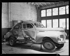 Damaged 1940 Plymouth sedan, Pelton Motor Company Paint Shop, 620 West 18th Street, Los Angeles, CA, 1940