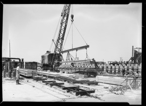 Treating concrete piles with asphalt, Southern California, 1932