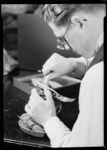 Man engraving initials on silver, Southern California, 1932