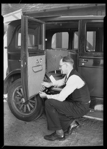 Putting seat covers on, rubber apron & covers etc., Southern California, 1930