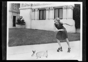 Girl on skates chasing rabbit at Figueroa Playhouse, 940 South Figueroa Street, Los Angeles, CA, 1928