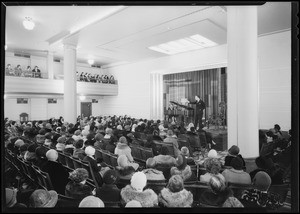 New shot of exposition room, women with hats on, Southern California, 1930