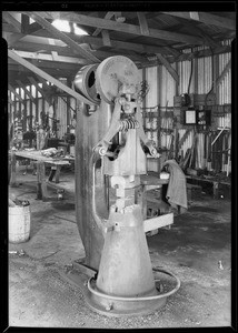 Bolts holding hammer to cement floor, Southern California, 1930