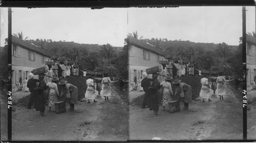 Women carrying earth in boxes on their heads in the streets of Fort de France. Martinique, West Indies