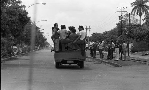People riding in a truck, Managua, 1979