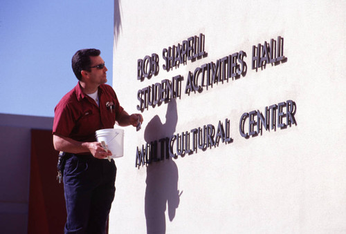 Worker Painting MC Center sign