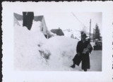 Man with mail standing outside in the snow